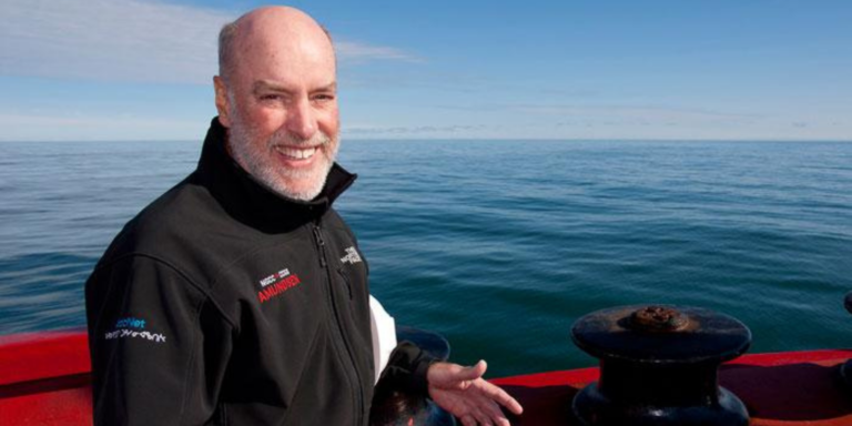 Louis Fortier looks at the camera from a boat on the water