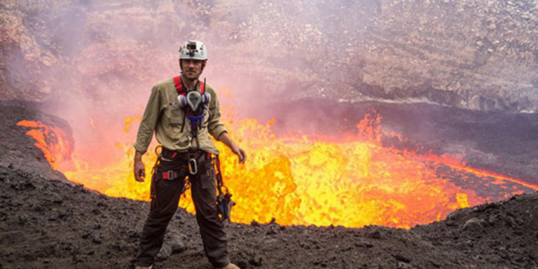 George Kourounis stands in front of lava