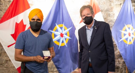 Gurdeep Pandher (left) receives the Louie Kamookak Medal from RCGS CEO John Geiger (right).
